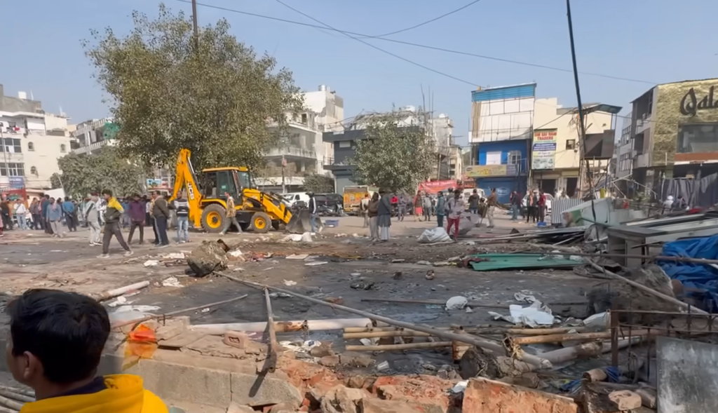 MCD Bulldozer Drive in Delhi’s Janakpuri Market Sparks Chaos; Electricity Poles Collapse, Traders Allege ‘No Notice’ MCD Bulldozer Drive in Delhi’s Janakpuri Market Sparks Chaos; Electricity Poles Collapse, Traders Allege ‘No Notice’
