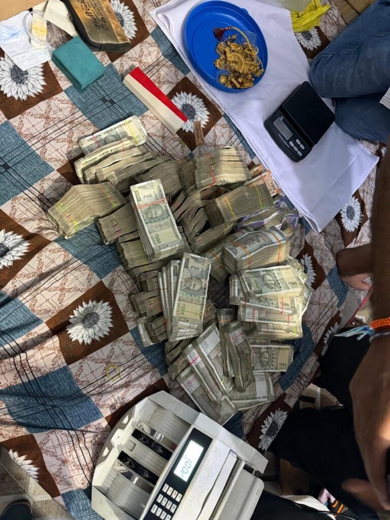 Bundles of currency, jewellery, a weighing scale and a cash-counting machine in a police-supplied photograph