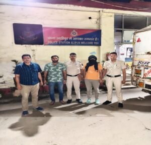 Delhi Police Seize 4,500 Liquor Quarters in Alipur; Driver Held Police personnel and a face-covered man outside Alipur police station in a photograph supplied by Delhi Police.