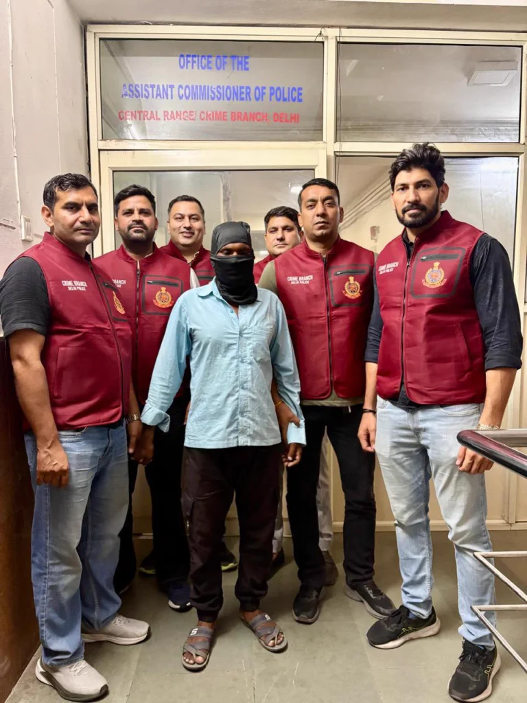 Delhi Police Arrest Accused Wanted in 2002 Okhla Murder Case Crime Branch officers with the masked accused arrested in the 2002 Okhla murder case