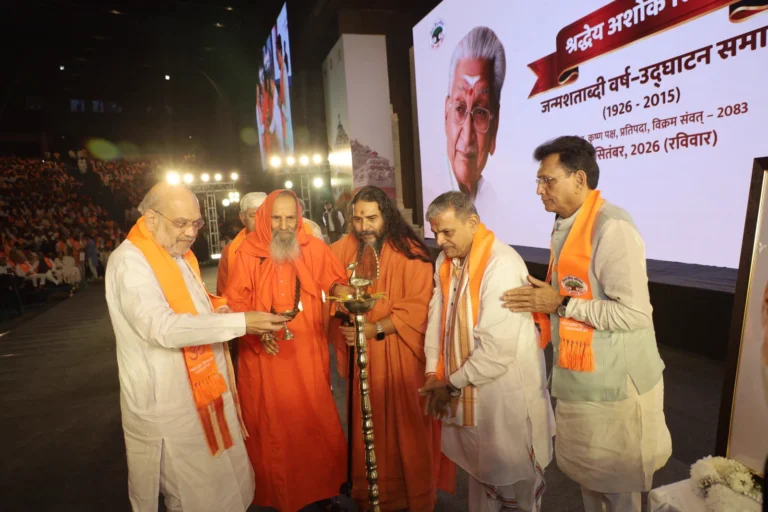 Amit Shah Inaugurates Ashok Singhal Birth Centenary Year at Bharat Mandapam Amit Shah lights a ceremonial lamp with other participants at the Ashok Singhal birth centenary event at Bharat Mandapam
