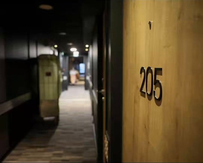 Hotel corridor and room door shown in West Delhi Police video of the Tilak Nagar gambling raid
