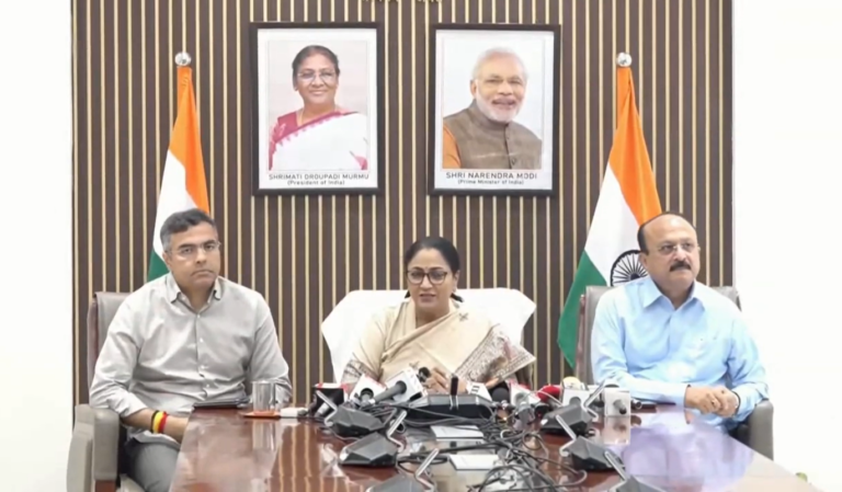 Delhi Chief Minister Rekha Gupta addressing the October 14 press conference, seated between two participants