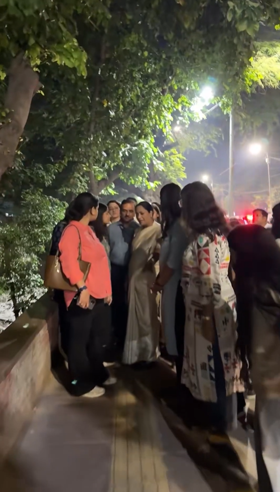 Rekha Gupta speaks with women students outside Delhi University’s Arts Faculty during an evening inspection