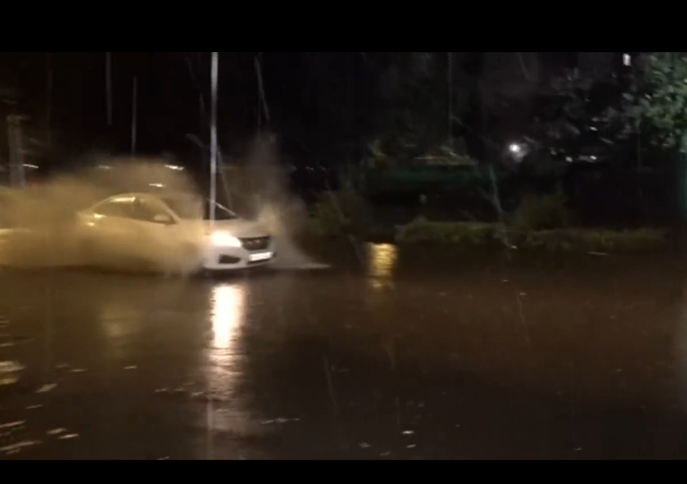 Delhi Rain Leaves Roads Waterlogged; IMD Morning Red Warning Covered All 11 Districts Car driving through water on a Delhi road during heavy rain