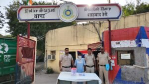 Shahbad Dairy Arms Arrest Leads Police to Robbery Case; Cash, ID Documents Recovered Police officers with a masked accused and recovered articles outside Shahbad Dairy police station