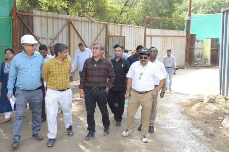 Officials inspect dust-control arrangements at a construction site