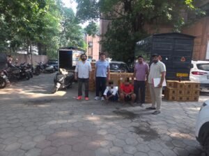 Alipur Liquor Seizure Triggers Probe Into Haryana–Delhi Supply Chain; 140 Cartons Recovered, Two Held Outer North Special Staff with seized liquor cartons, vehicles and two accused with pixelated faces