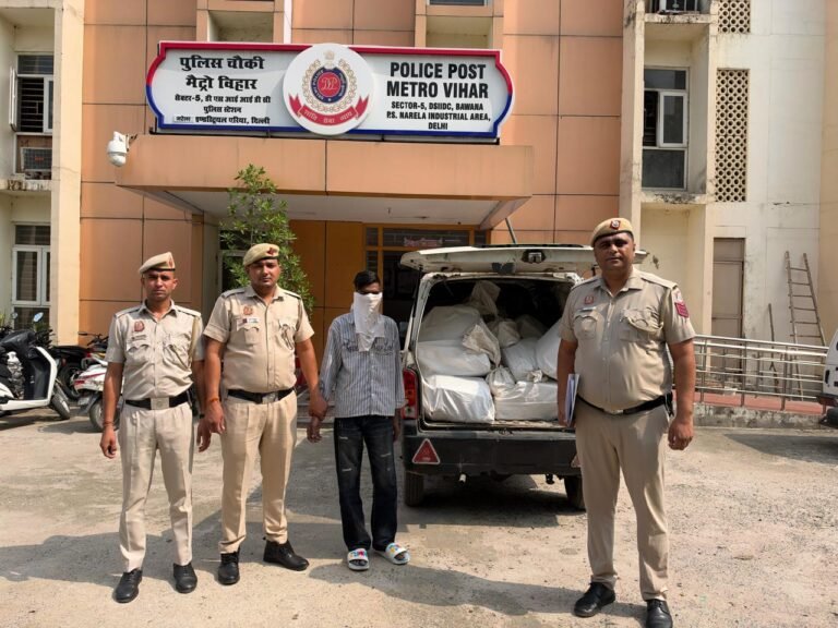 Delhi Police personnel with the seized Maruti Eeco outside Police Post Metro Vihar