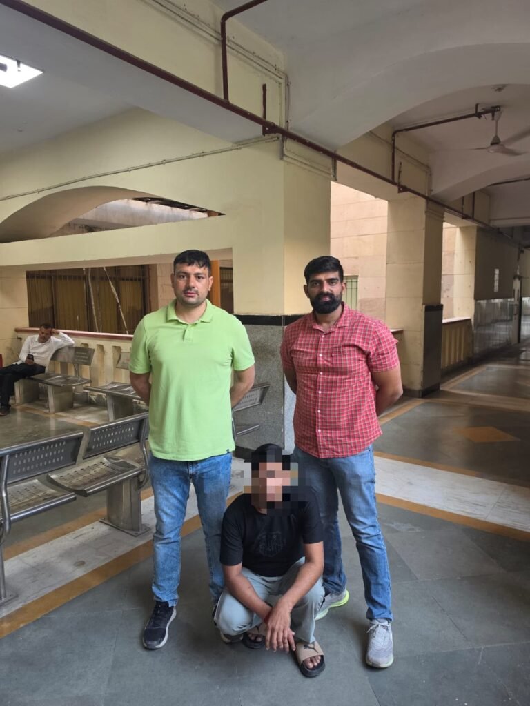 Budh Vihar Theft-Case Proclaimed Offender Held by AATS Outer North AATS Outer North personnel with the apprehended man whose face is pixelated