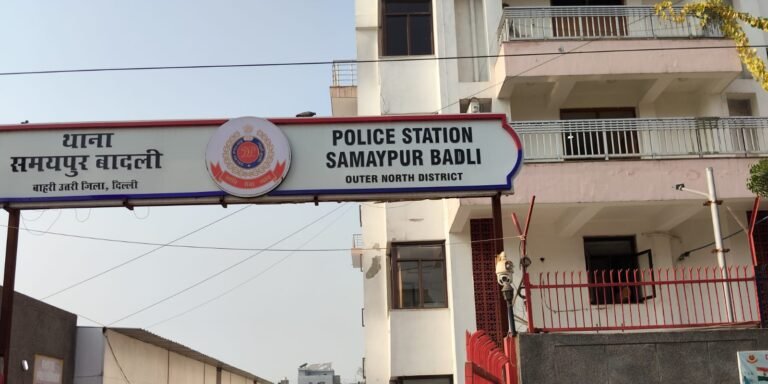 Hindi and English Samaypur Badli police station sign above the station building