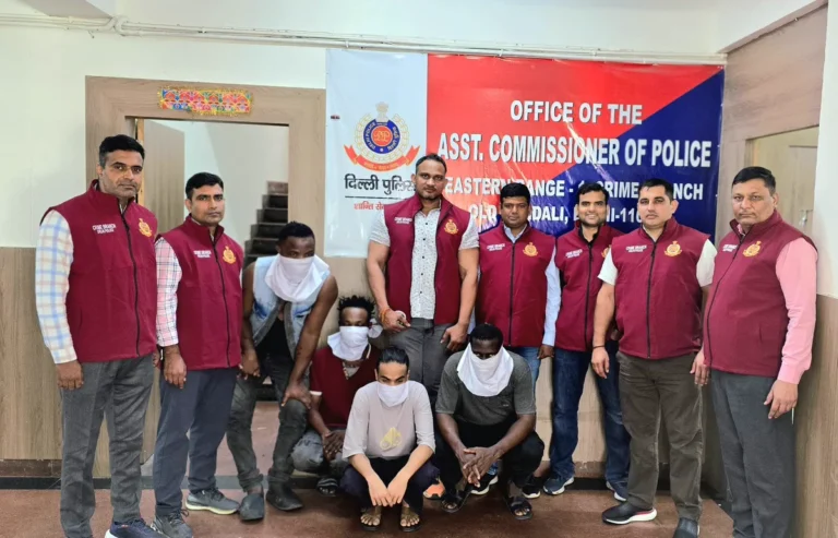 Delhi Crime Branch personnel with four face-covered people in the MDMA and cocaine case photograph