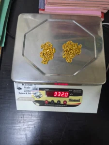 Delhi Customs seizes 332g gold worth Rs 47.38 lakh from two Sharjah passengers Two gold chains on a weighing scale showing 332.0 grams in Delhi Customs seizure photograph