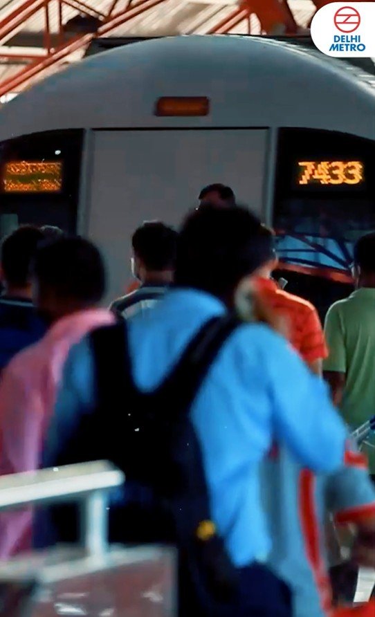 Passengers approaching a Delhi Metro train at a station — portrait video still