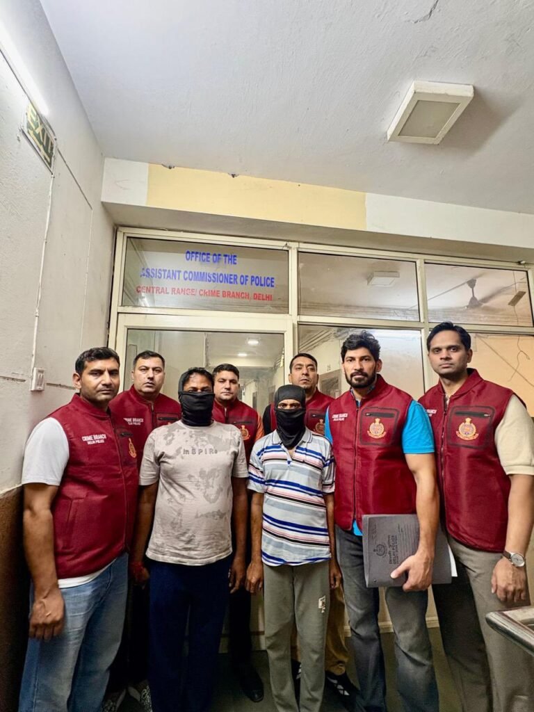 Crime Branch officers with two men whose faces are covered in the official Central Range photograph