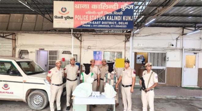 Burglary Suspect Found Asleep Inside Delhi House; Two Arrested, Police Say Police and two face-obscured men with recovered property outside Kalindi Kunj police station