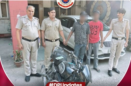 Madhu Vihar Police Recover Phone, Stolen Motorcycle After Two Arrests Madhu Vihar police with two suspects whose faces remain blurred and the recovered motorcycle