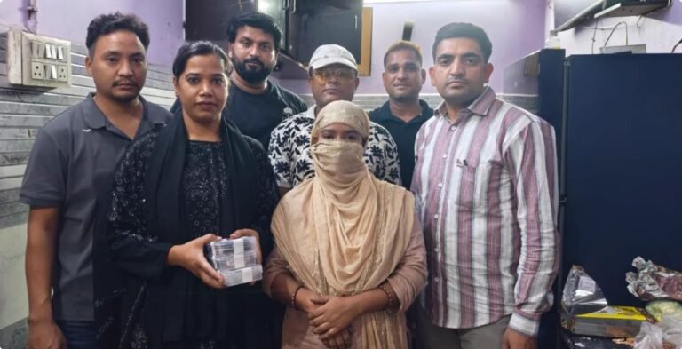 Police personnel with a face-covered woman in the Jahangirpuri heroin case photograph