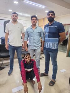 Outer North Police Apprehend Proclaimed Offender in 2017 Narela Case A seated pixelated person with three people standing behind.