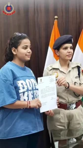 Woman helps nab phone snatchers after scooter chase near Shalimar Bagh Metro A young woman and a police officer holding a document in Delhi Police’s Shalimar Bagh video still